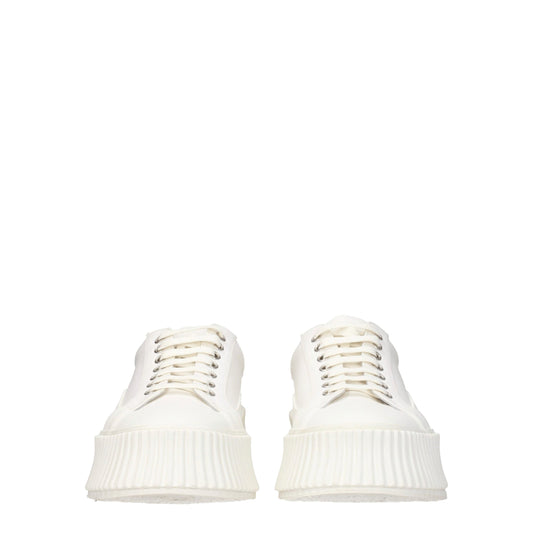 Pair of white platform sneakers with textured soles, lace-up front and elastic panels on sides