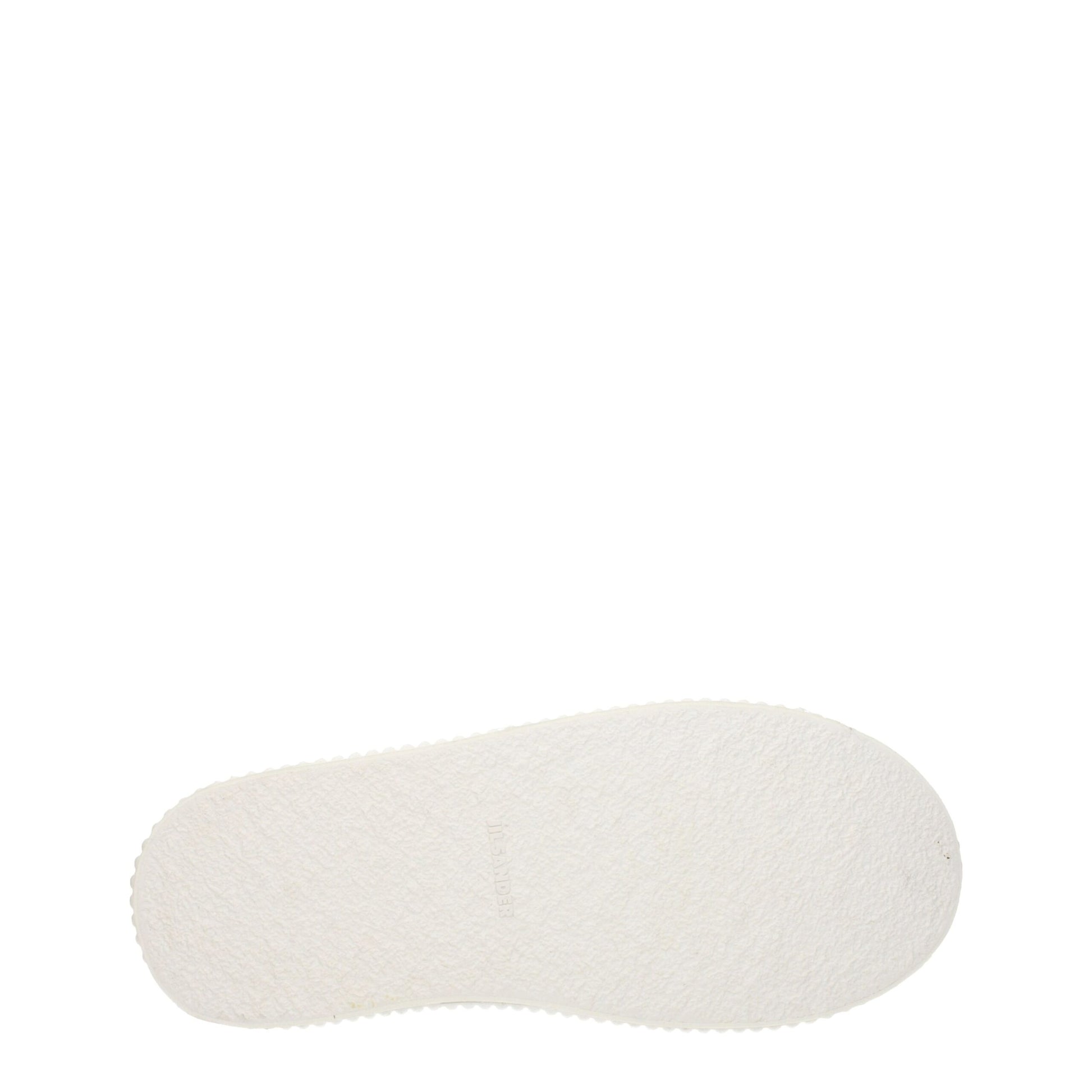 A single white sneaker with a platform sole