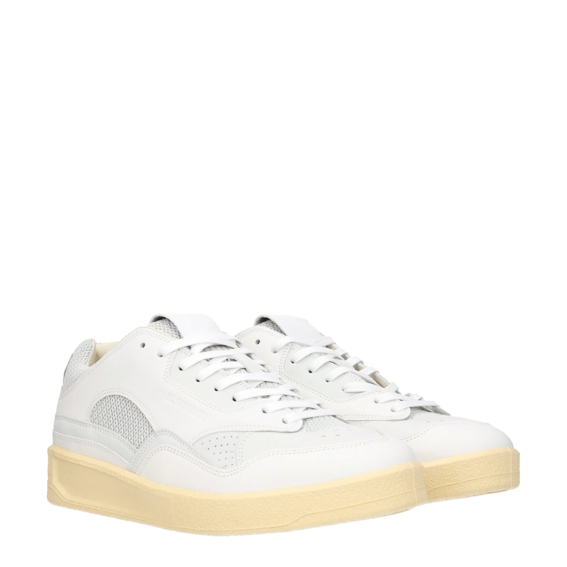 White leather low top sneakers with tan soles