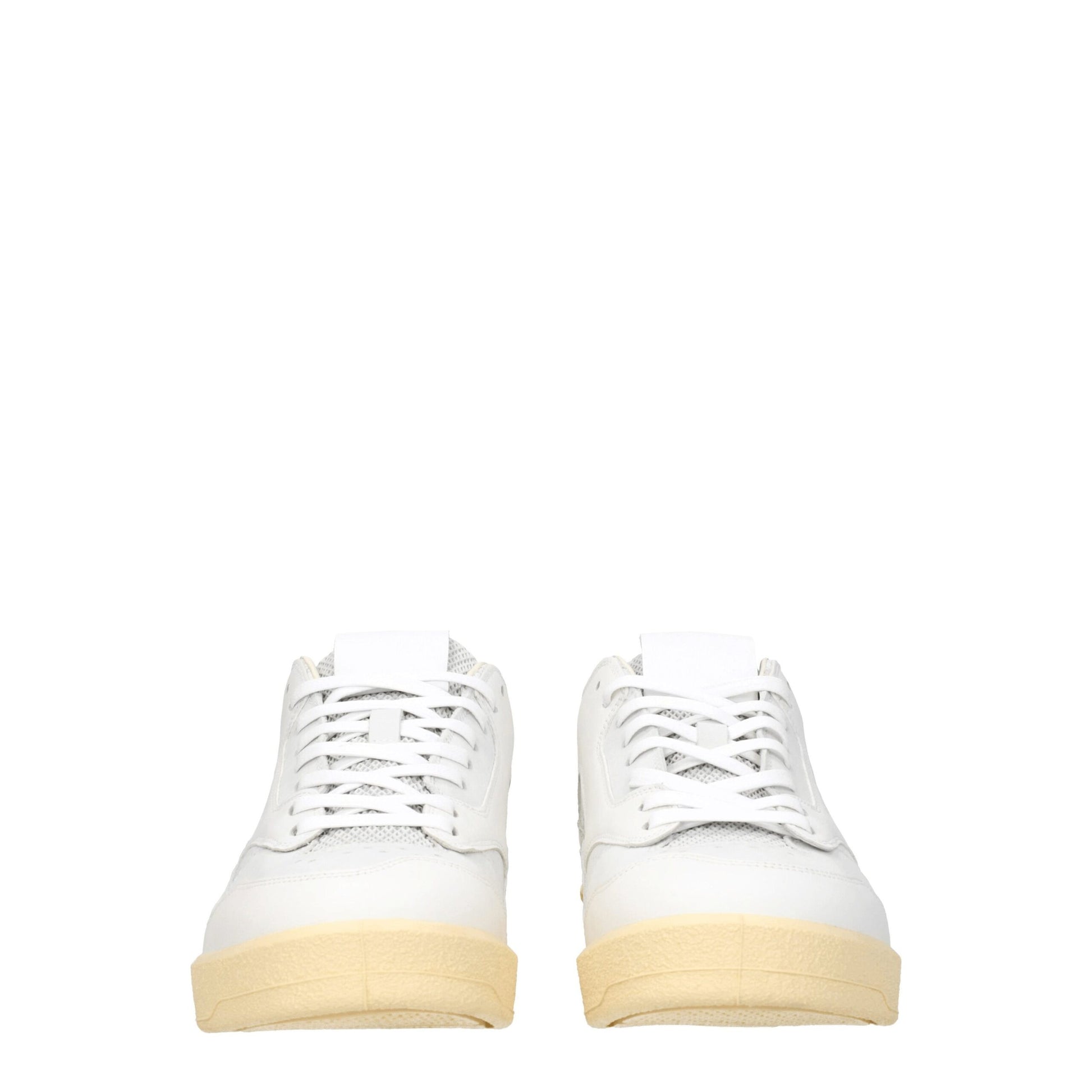Pair of white leather low top sneakers with tan soles