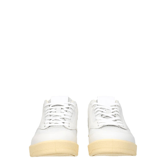 Pair of white leather low top sneakers with tan soles