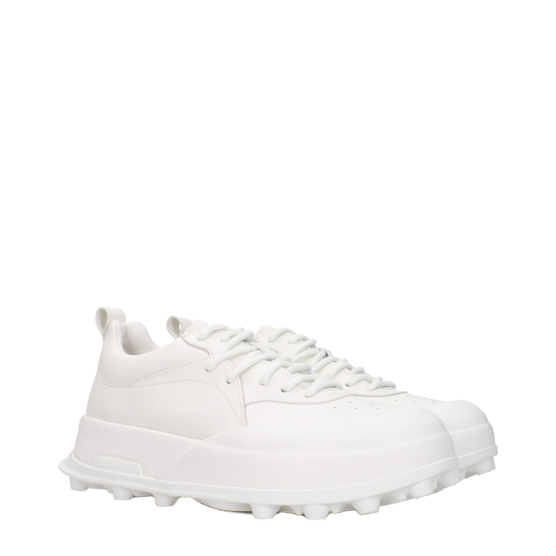 White leather sneakers with laces, featuring a low top design