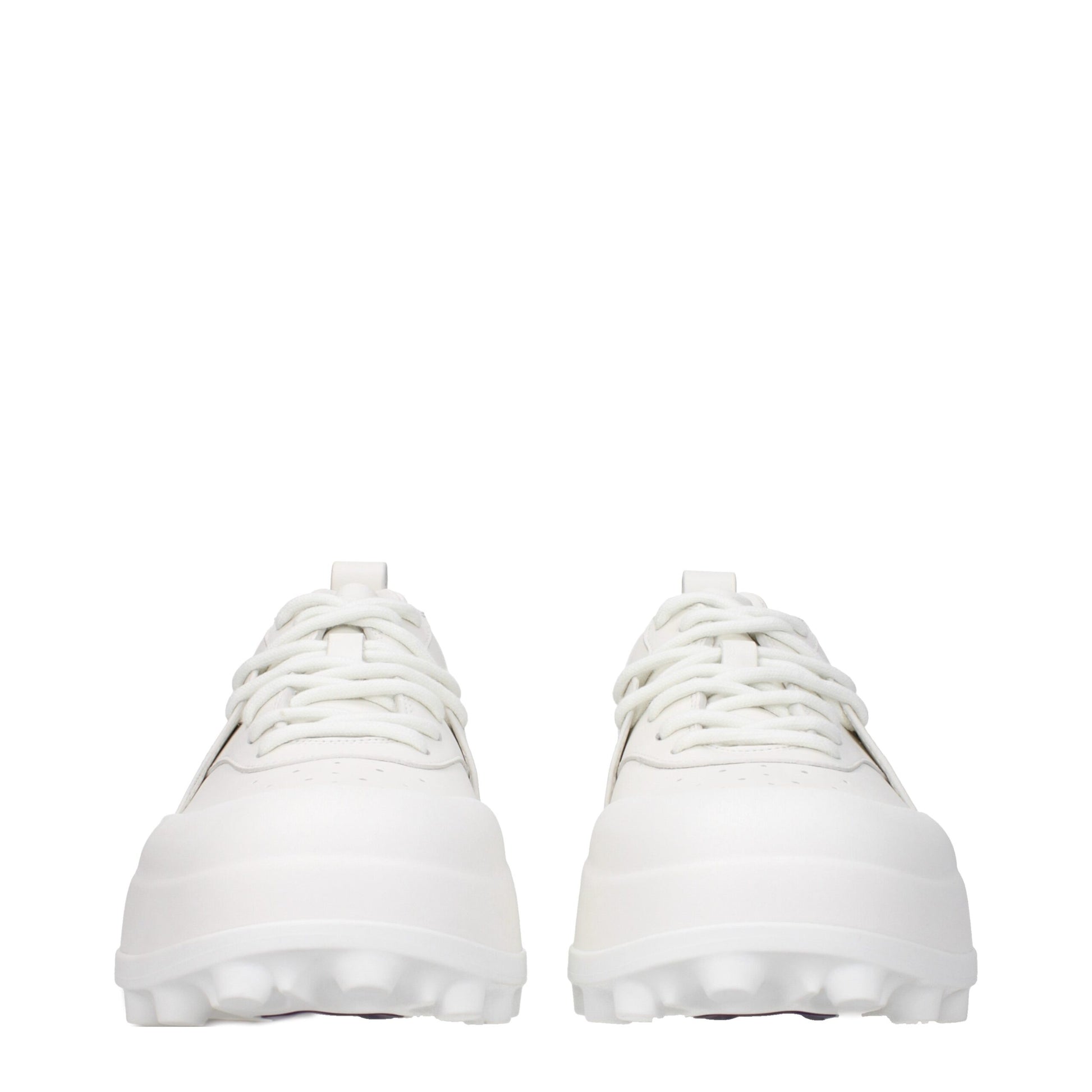 Pair of white leather sneakers with laces, featuring a low-top design and flat soles