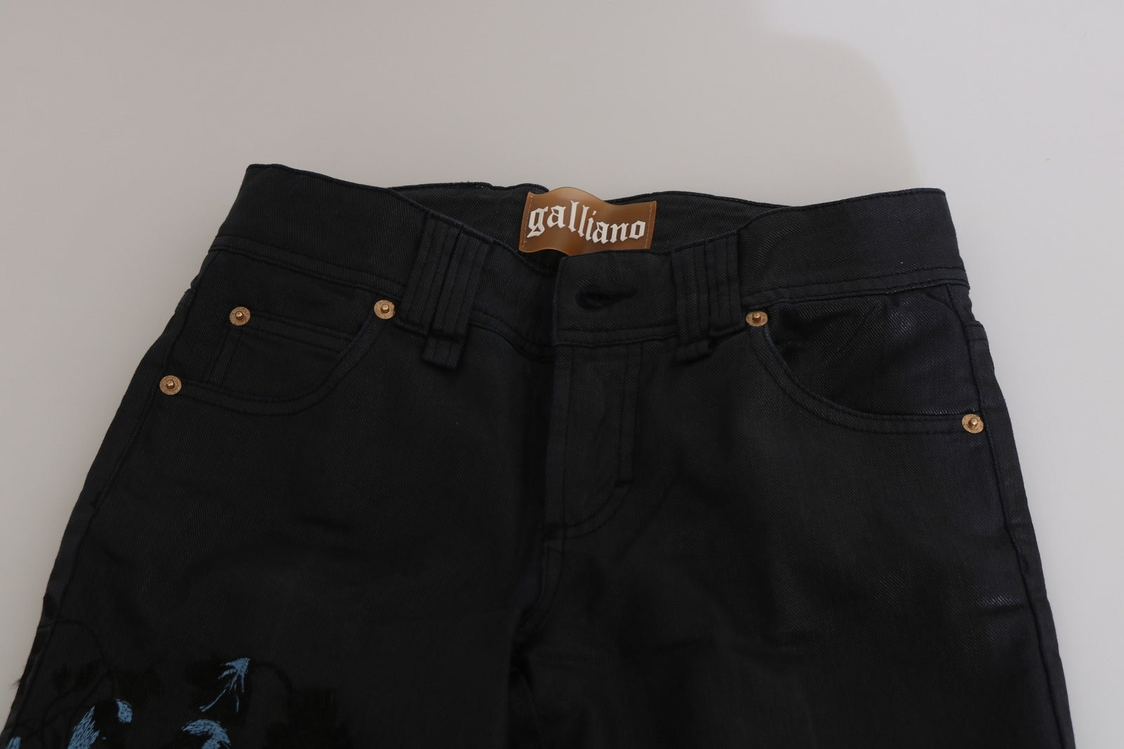 Pair of black jeans with gold buttons
