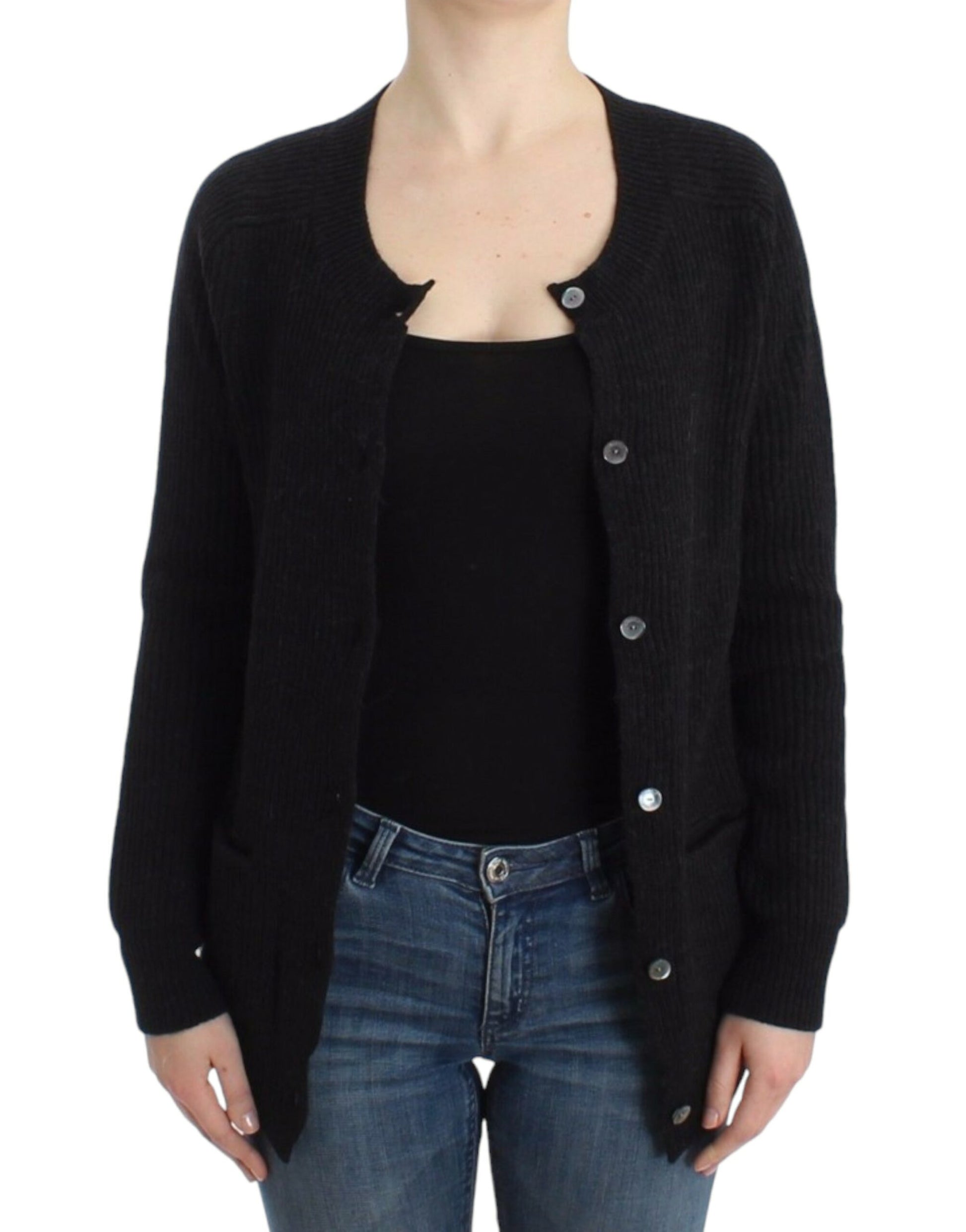 Woman wearing black cardigan over black shirt and blue jeans