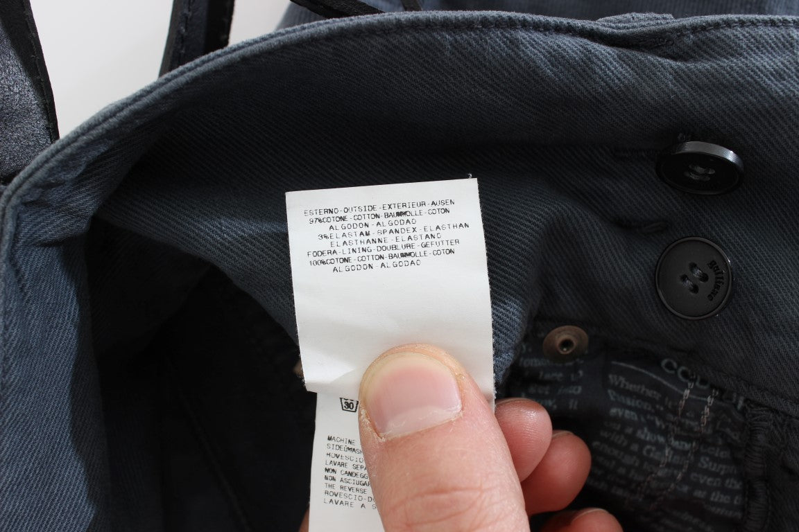 Hand holding tag on jeans jacket