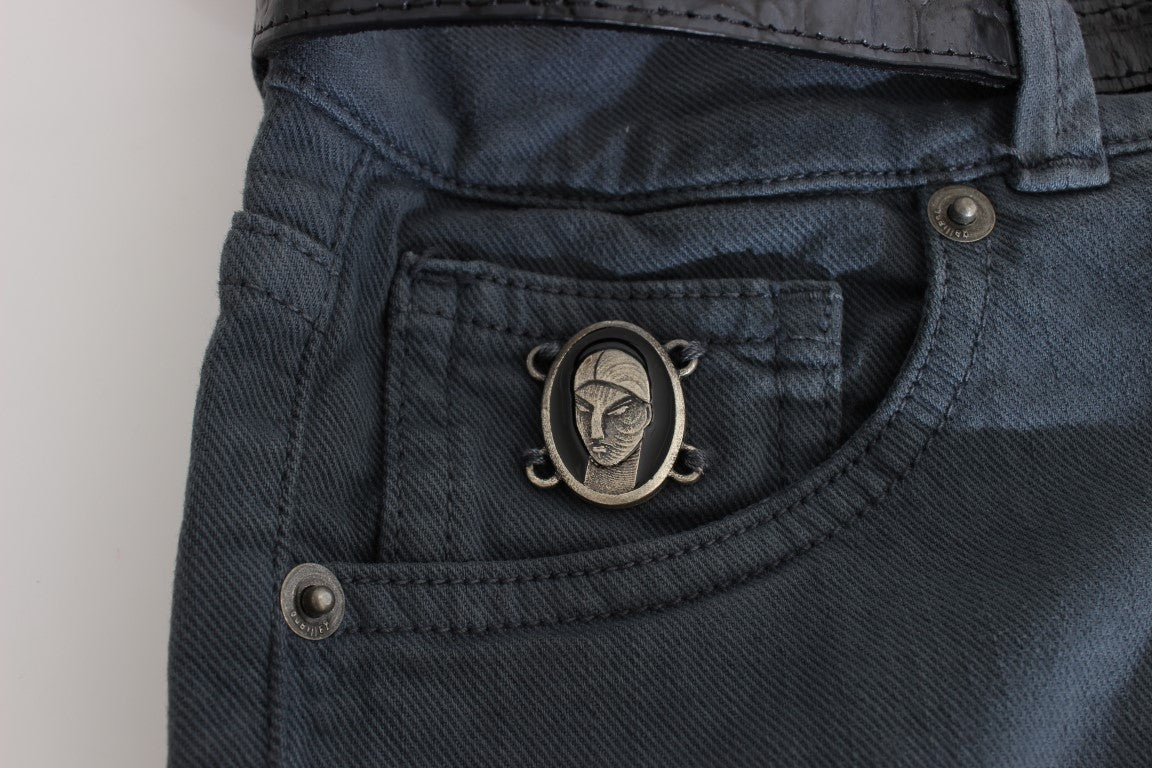 Pocket on blue jeans with silver skull ring