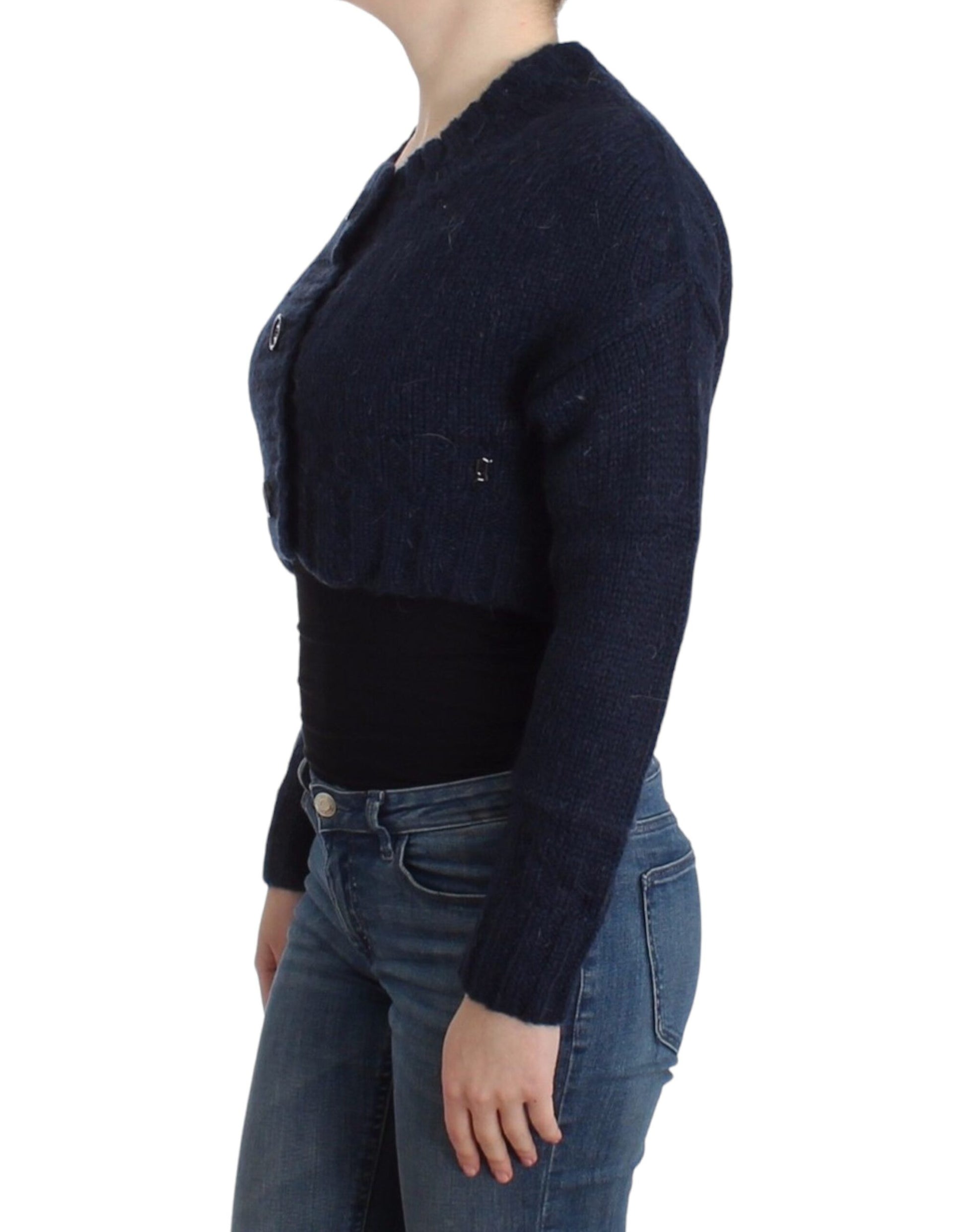 Woman wearing a blue sweater over black top and jeans