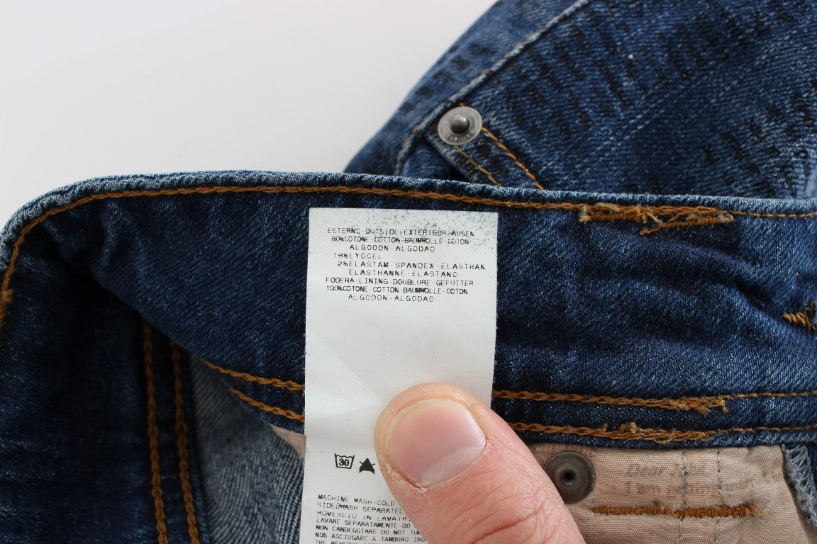Hand holding a white tag on blue denim jeans