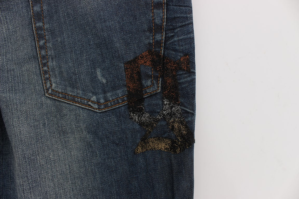 Pair of blue jeans with a gold design on the back pocket