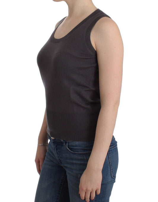 Woman wearing black tank top and blue jeans