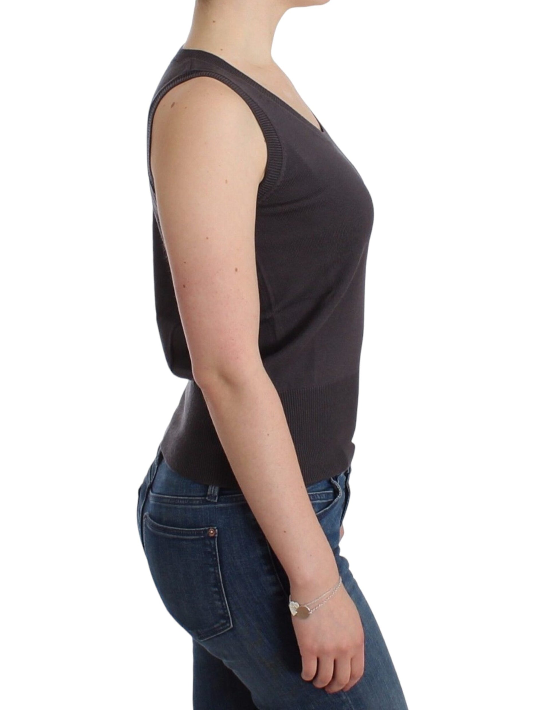 Woman wearing black tank top and blue jeans