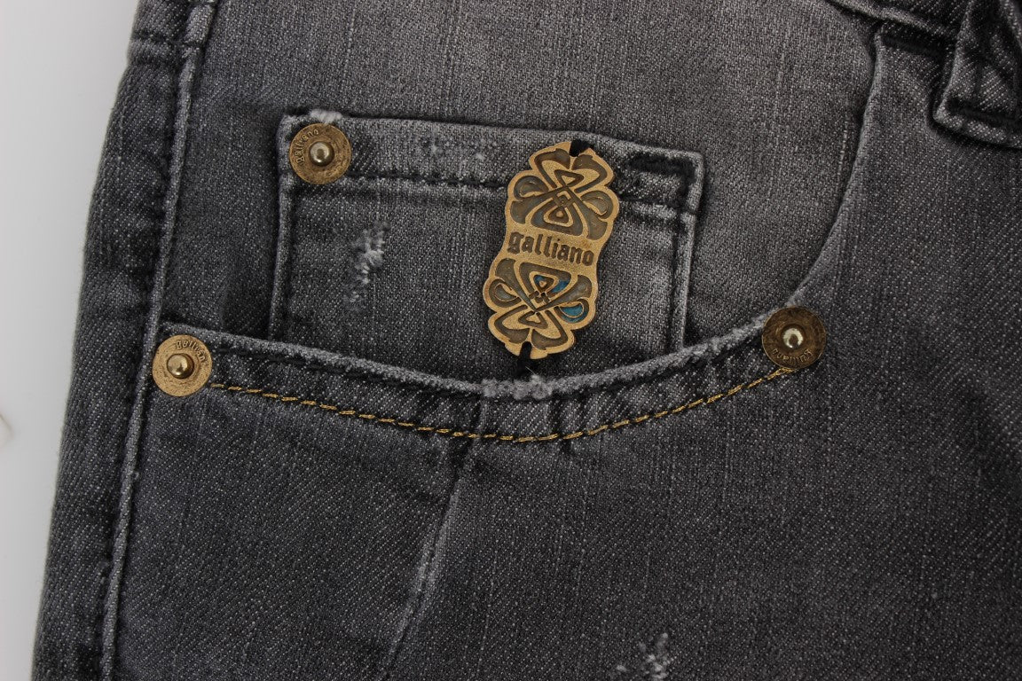 Pair of blue jeans with gold buttons and a small embroidered emblem on the right side pocket