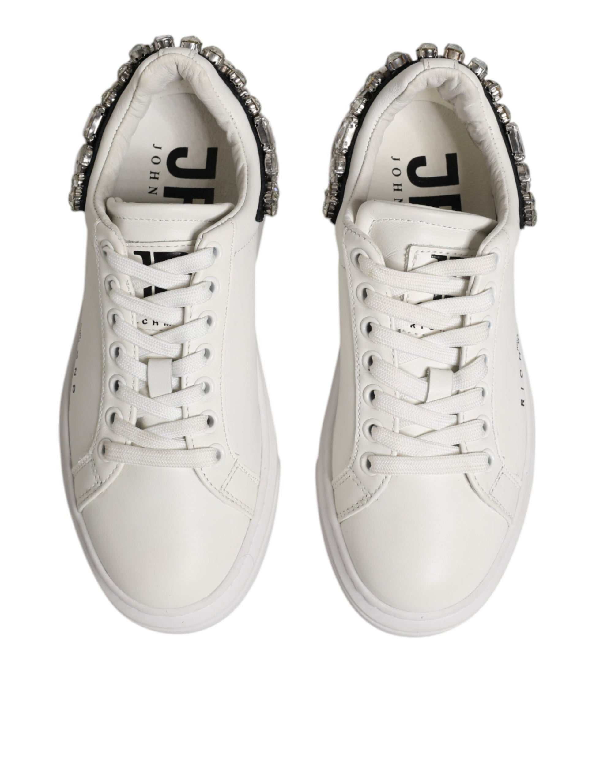 Pair of white sneakers with rhinestones on side