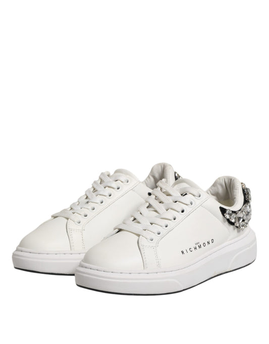 Pair of white sneakers with rhinestones, featuring a low-top design and lace closure