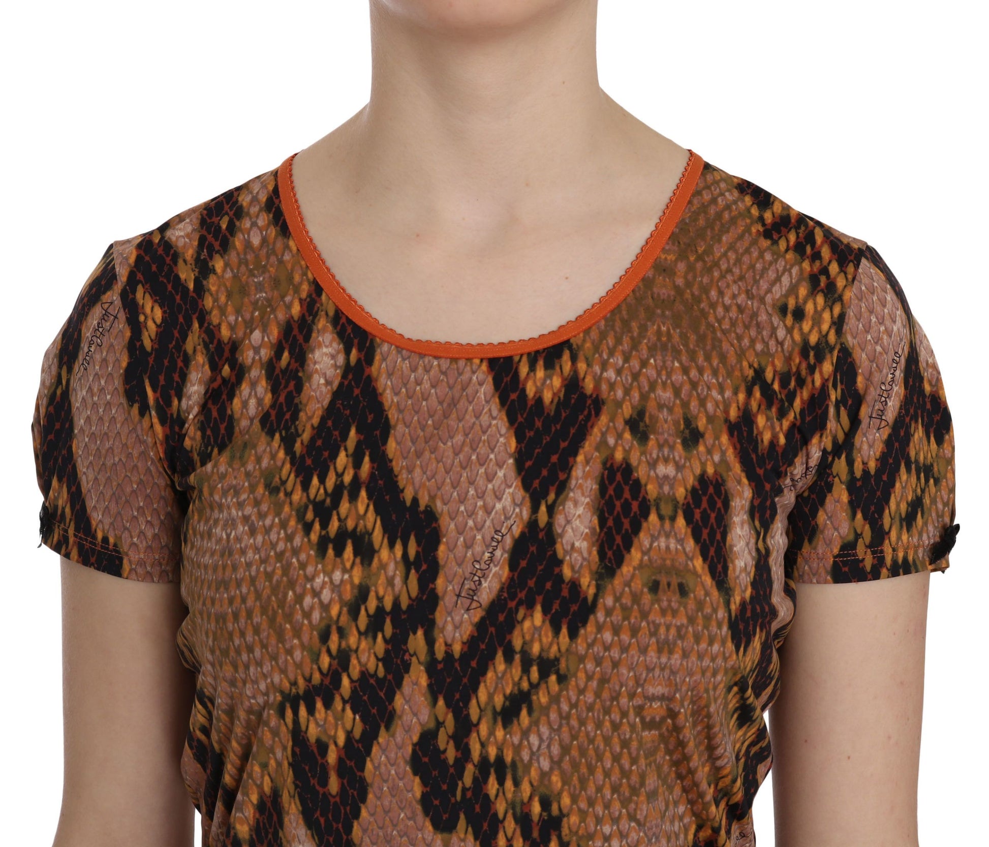 A woman wearing a top with a snake skin print
