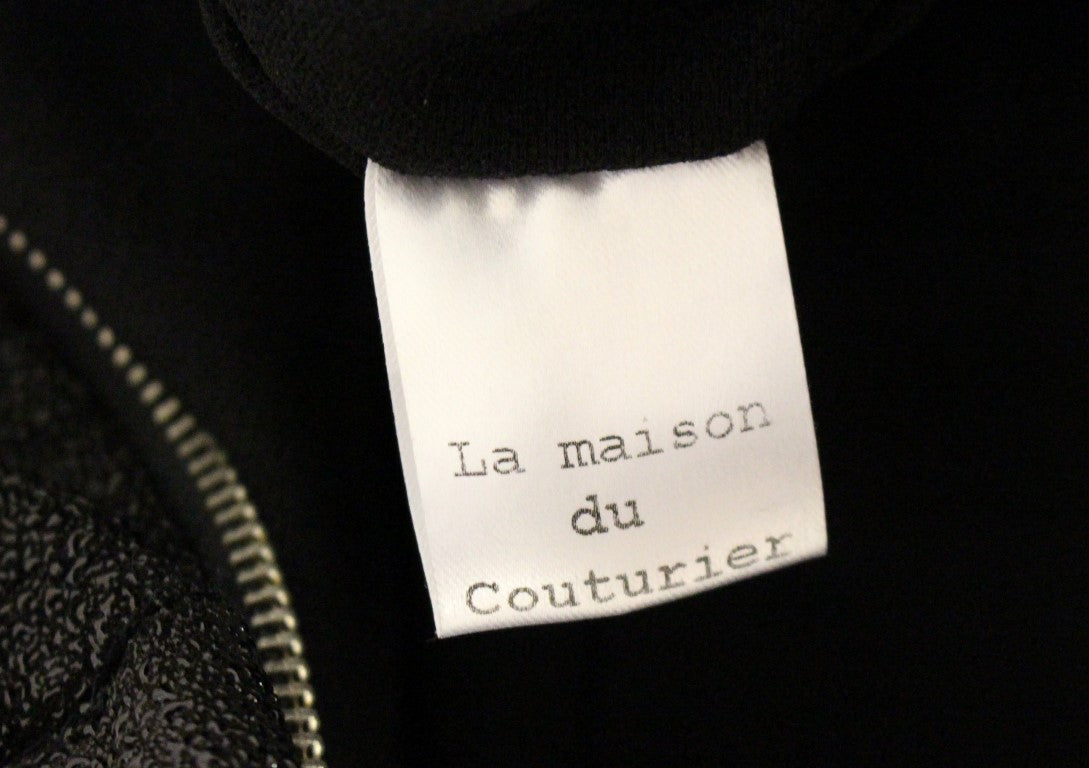 Tag on a black jacket reading "La Maison du Couturier"
