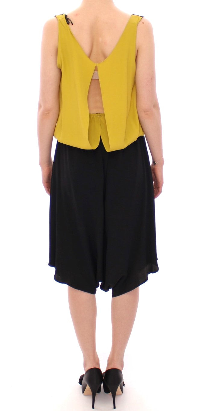 Yellow sleeveless top with black skirt