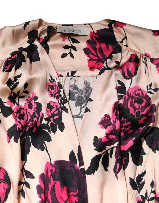 A pink floral silk dress with long sleeves and a V-neck