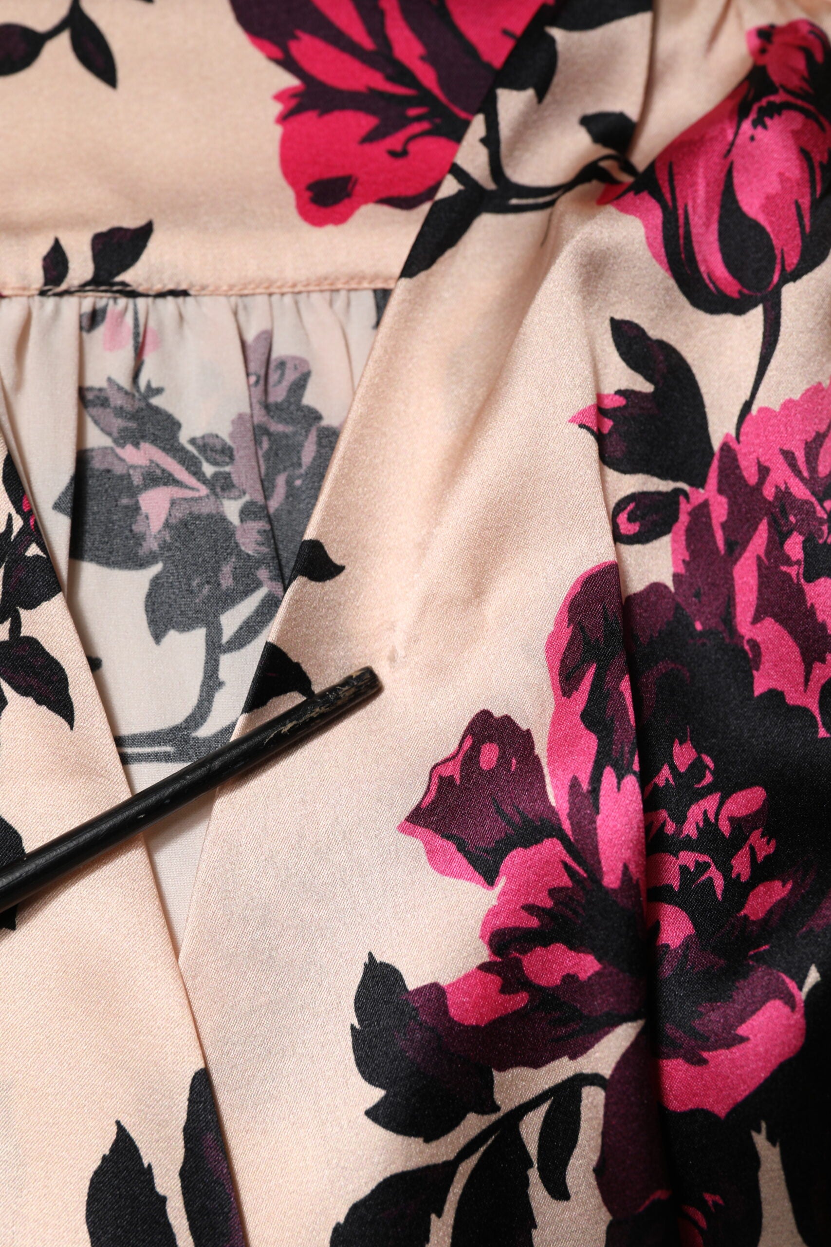 A pink floral silk dress with long sleeves and a V-neck