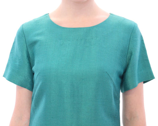 Short sleeve teal top on a mannequin