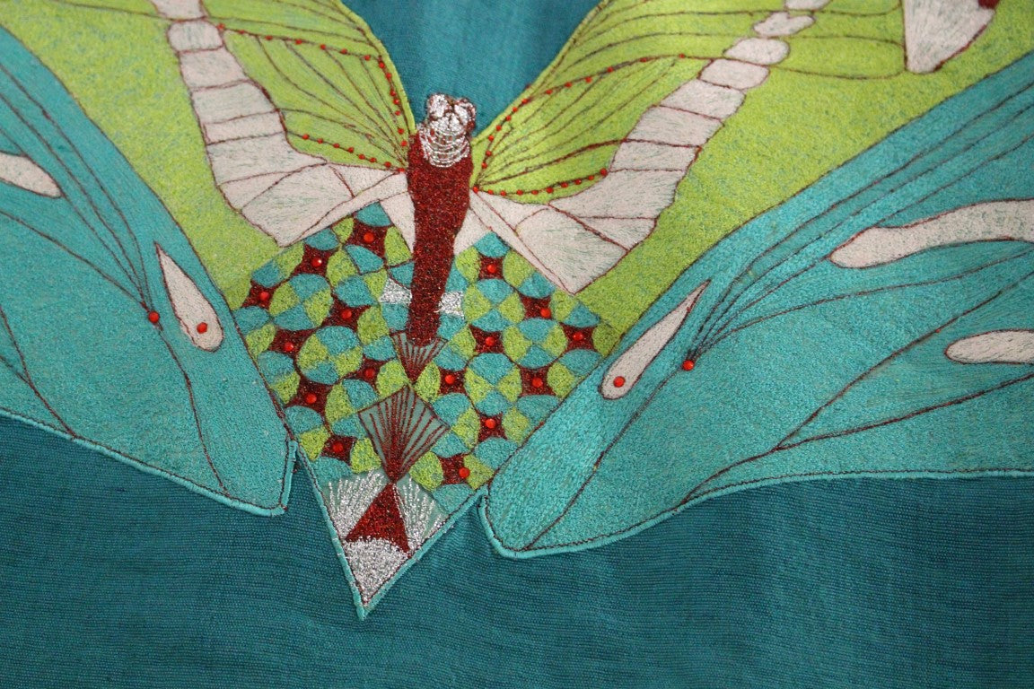 Embroidered dragonfly on fabric