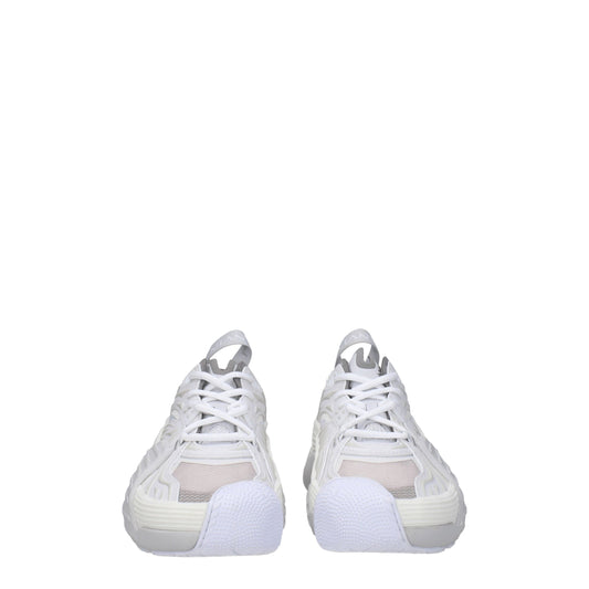 Pair of white leather athletic sneakers with laces, featuring a textured upper and a low-top design