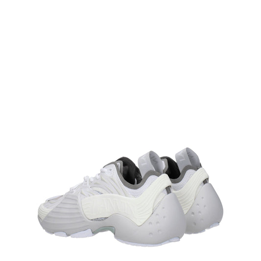 Pair of white leather athletic sneakers with black laces, featuring a textured design and a low-top style