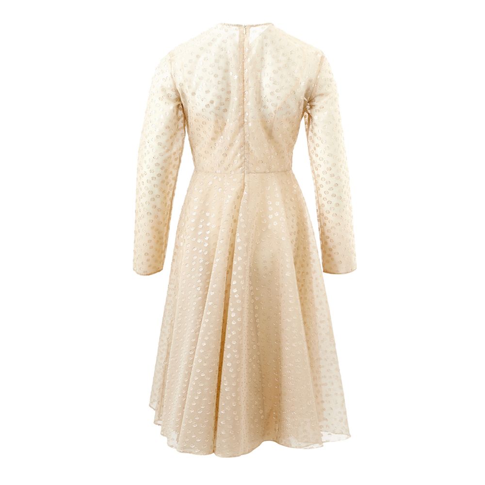 A beige cotton cocktail dress with a polka dot pattern on the bodice and sleeves