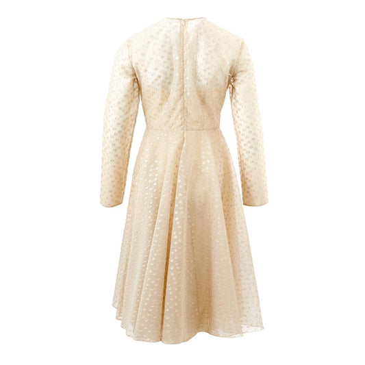 A beige cotton cocktail dress with a polka dot pattern on the bodice and sleeves