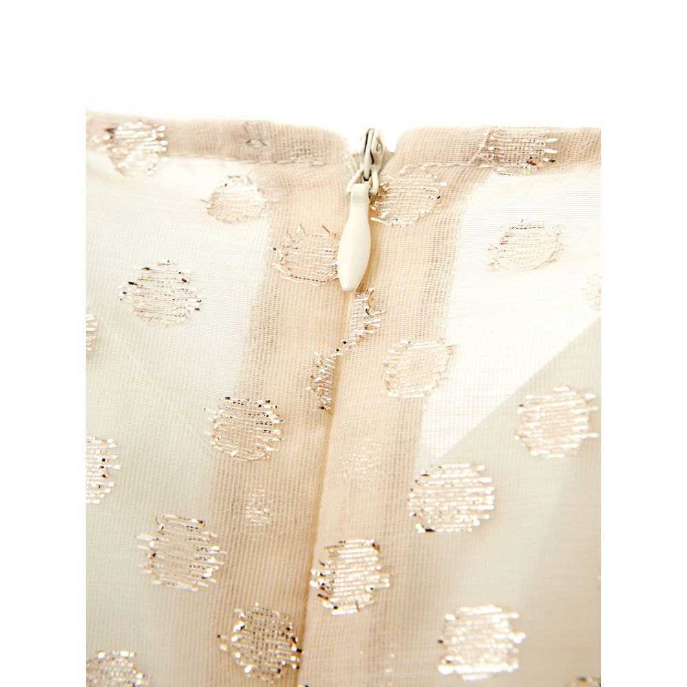 A beige cotton cocktail dress with sequin detailing on the bodice and sleeves