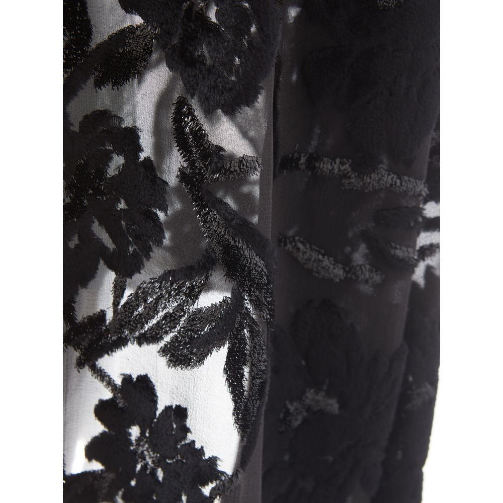 A black cocktail dress with lace detailing on sleeves and bodice
