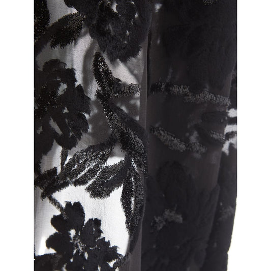 A black cocktail dress with lace detailing on sleeves and bodice
