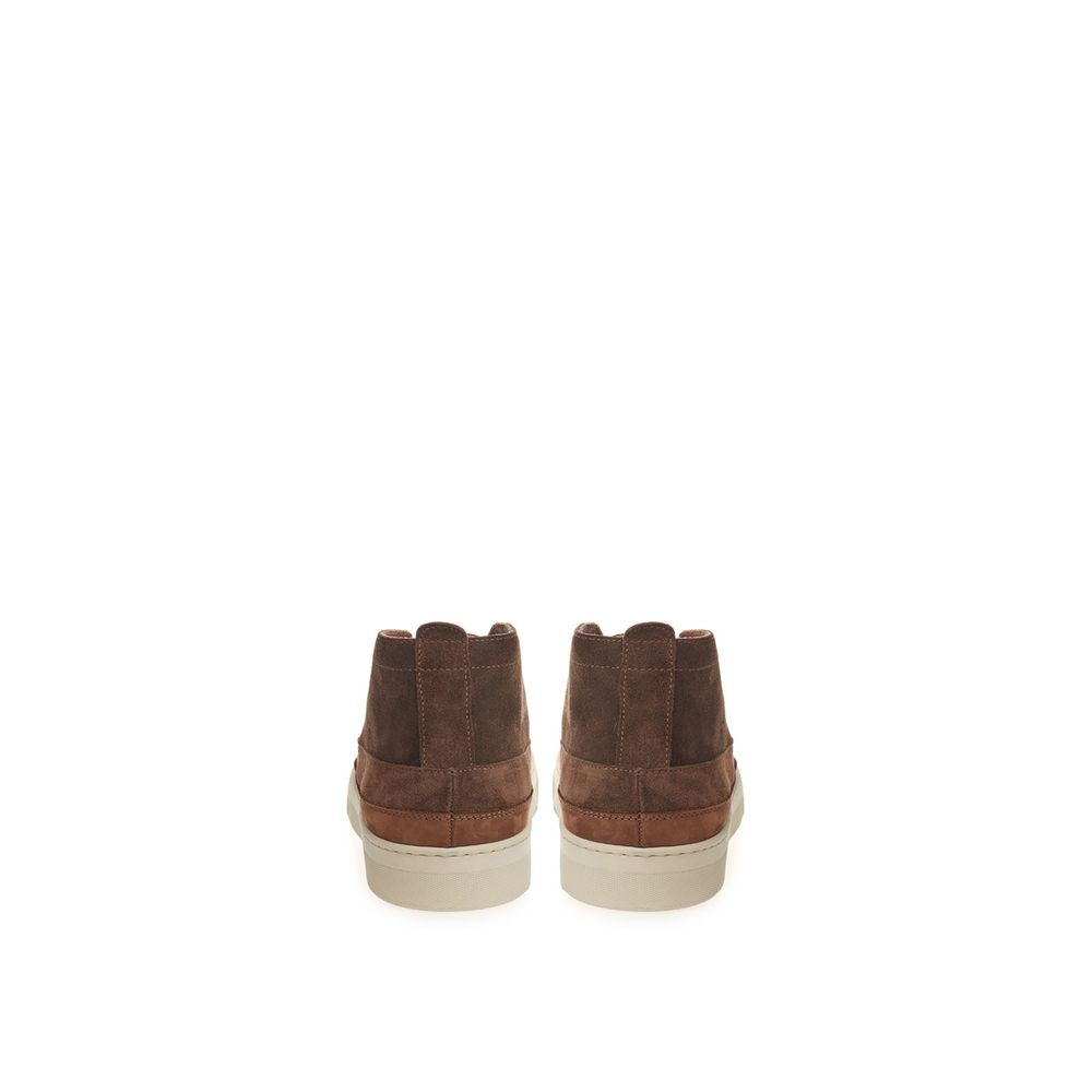 Pair of brown suede boots with white soles