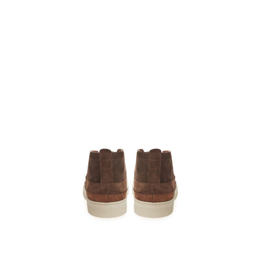Pair of brown suede boots with white soles