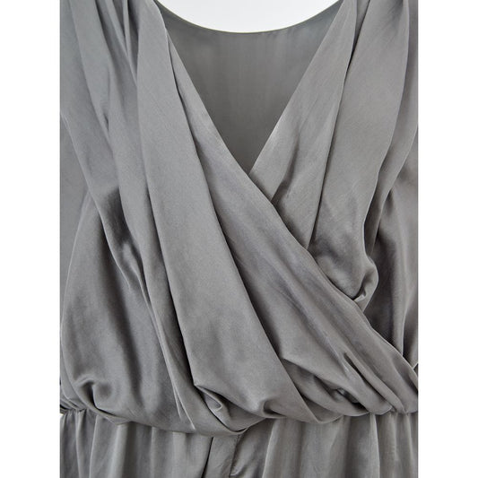 A gray silk casual dress with a V-neckline and draped sleeves