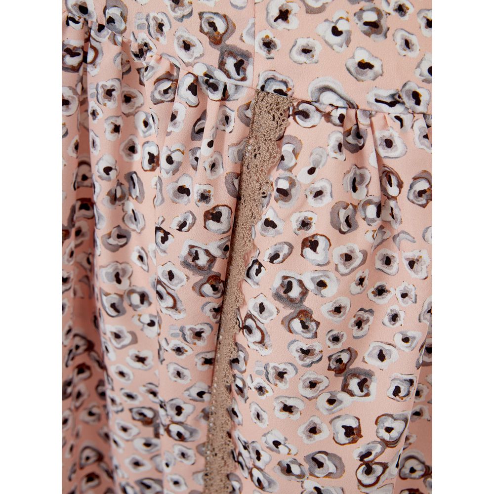 A pink dress with a pattern of small circles, featuring a high waist and a long skirt