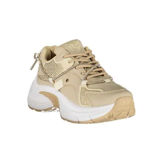 Tan women's sneaker with lace-up closure, embellished with gold accents and a patterned design on the side