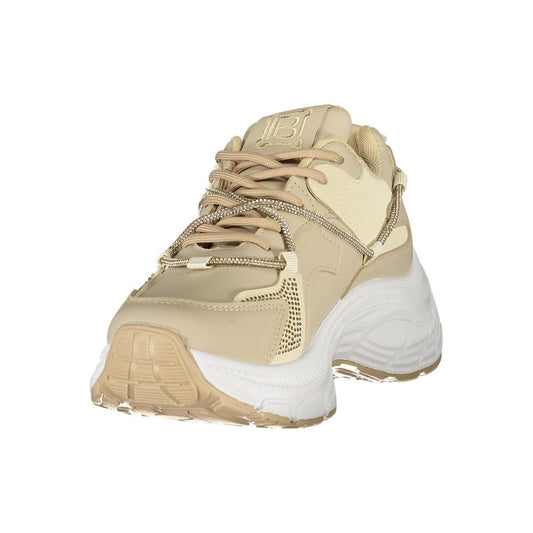 A beige women's sneaker with a gold chain design on the side