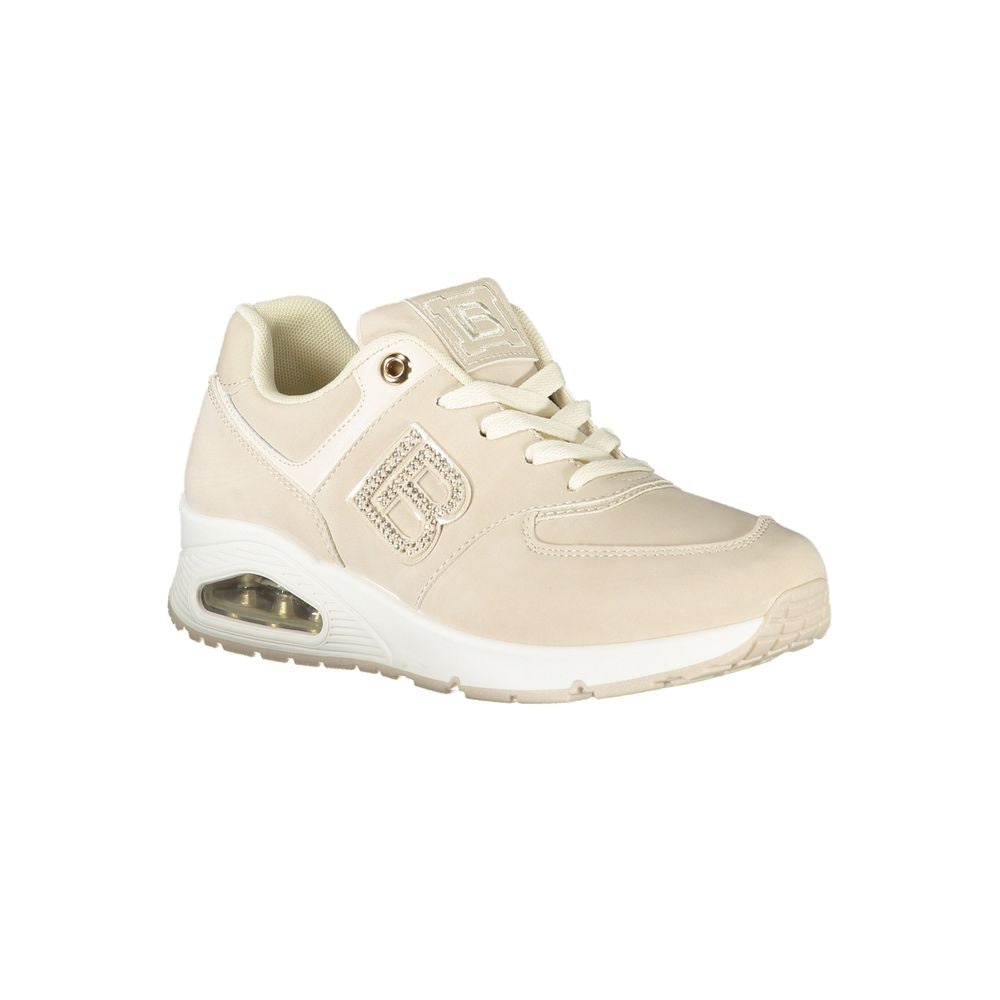 Tan women's sneakers with lace-up closure, gold accents, and chunky sole