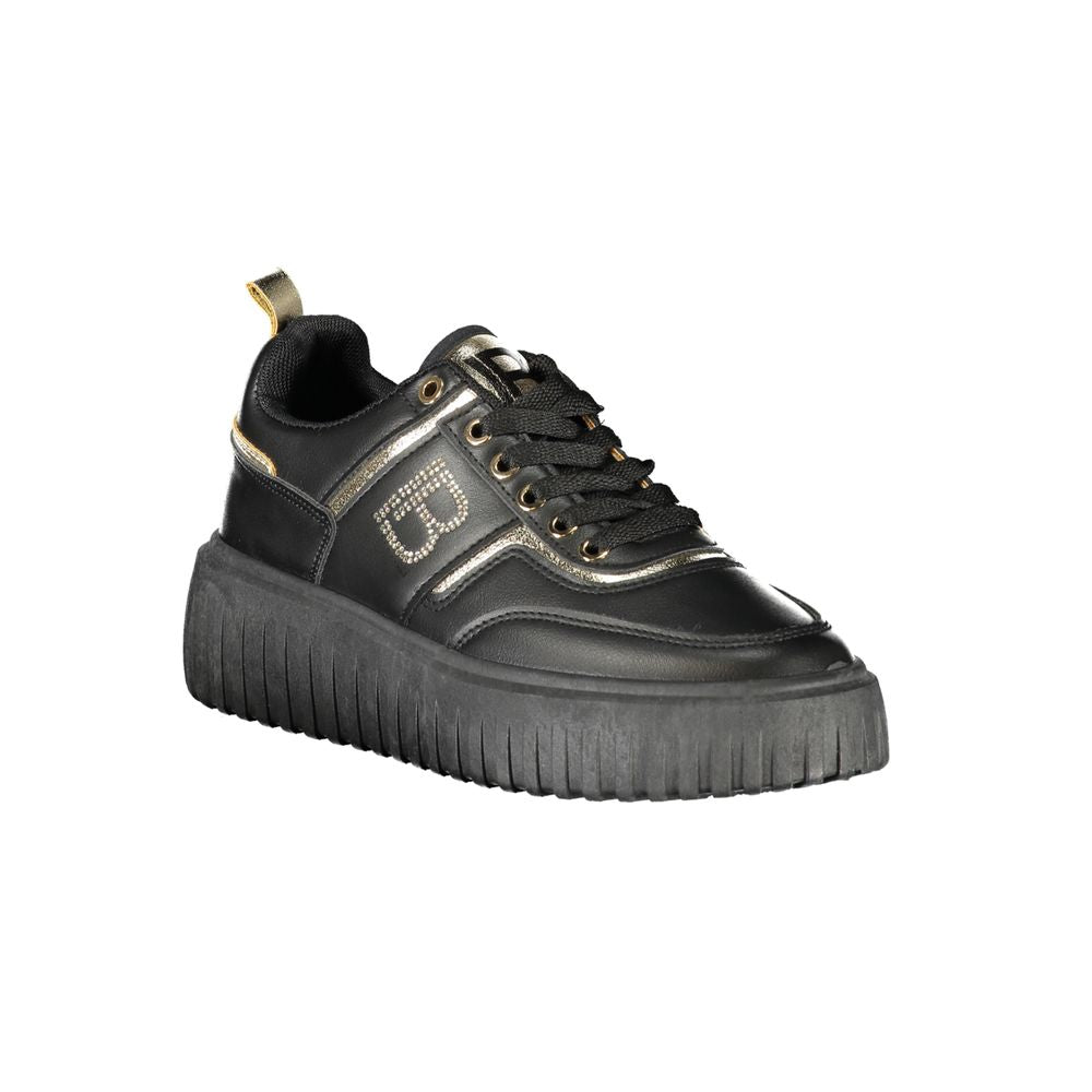A black women's sneaker with a gold buckle, featuring a chunky sole and a lace-up front