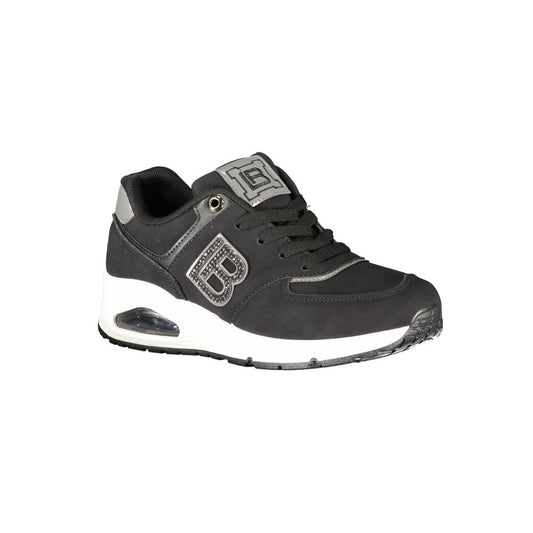 A black women's sneaker with white sole, featuring a logo on the side and a strap across the top