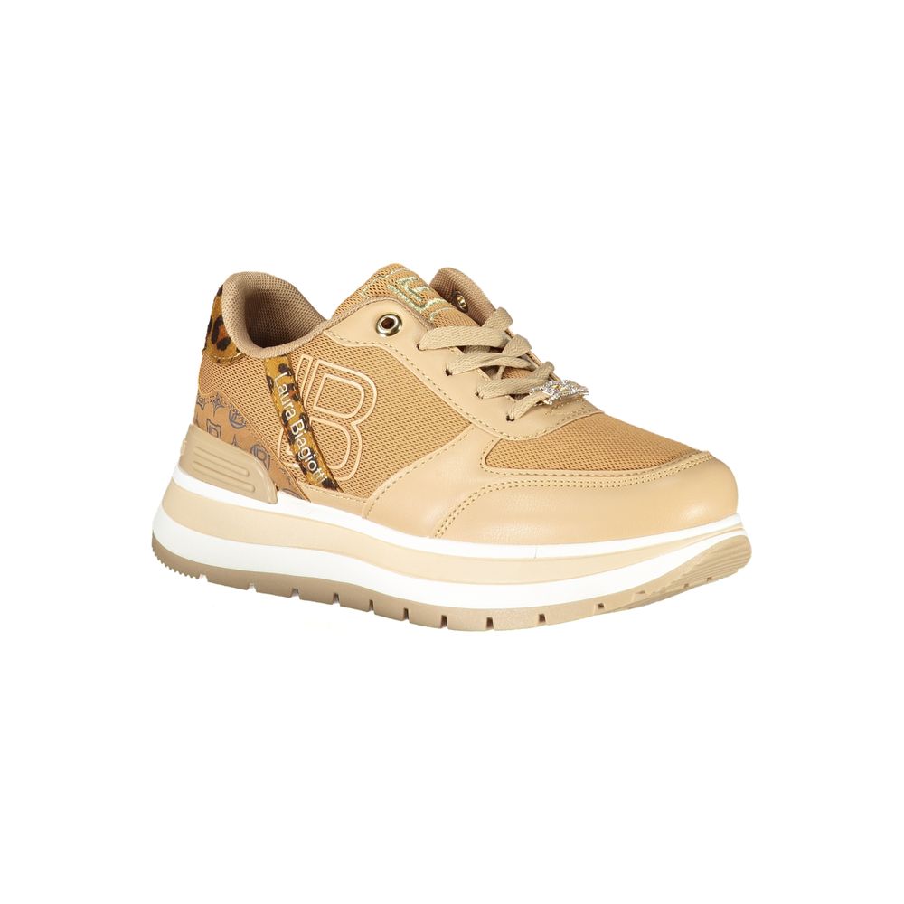 Tan women's sneaker with white sole, featuring a lace-up front and embellishments on the side