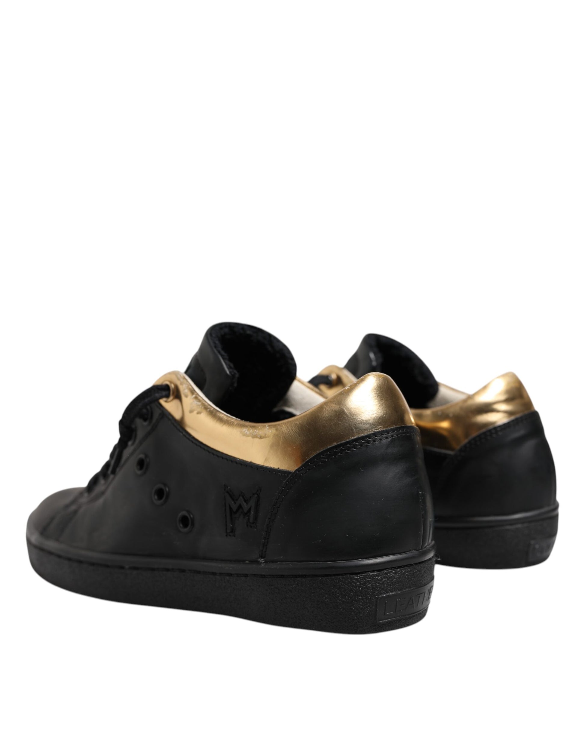 Pair of black sneakers with gold accents