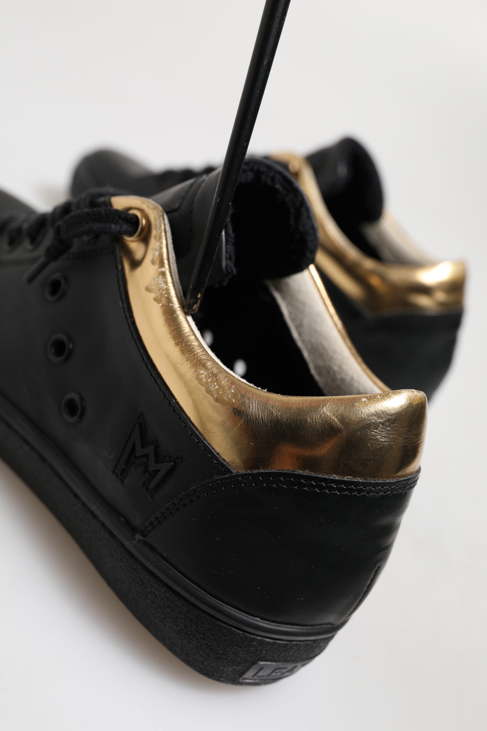Black and gold sneakers with laces