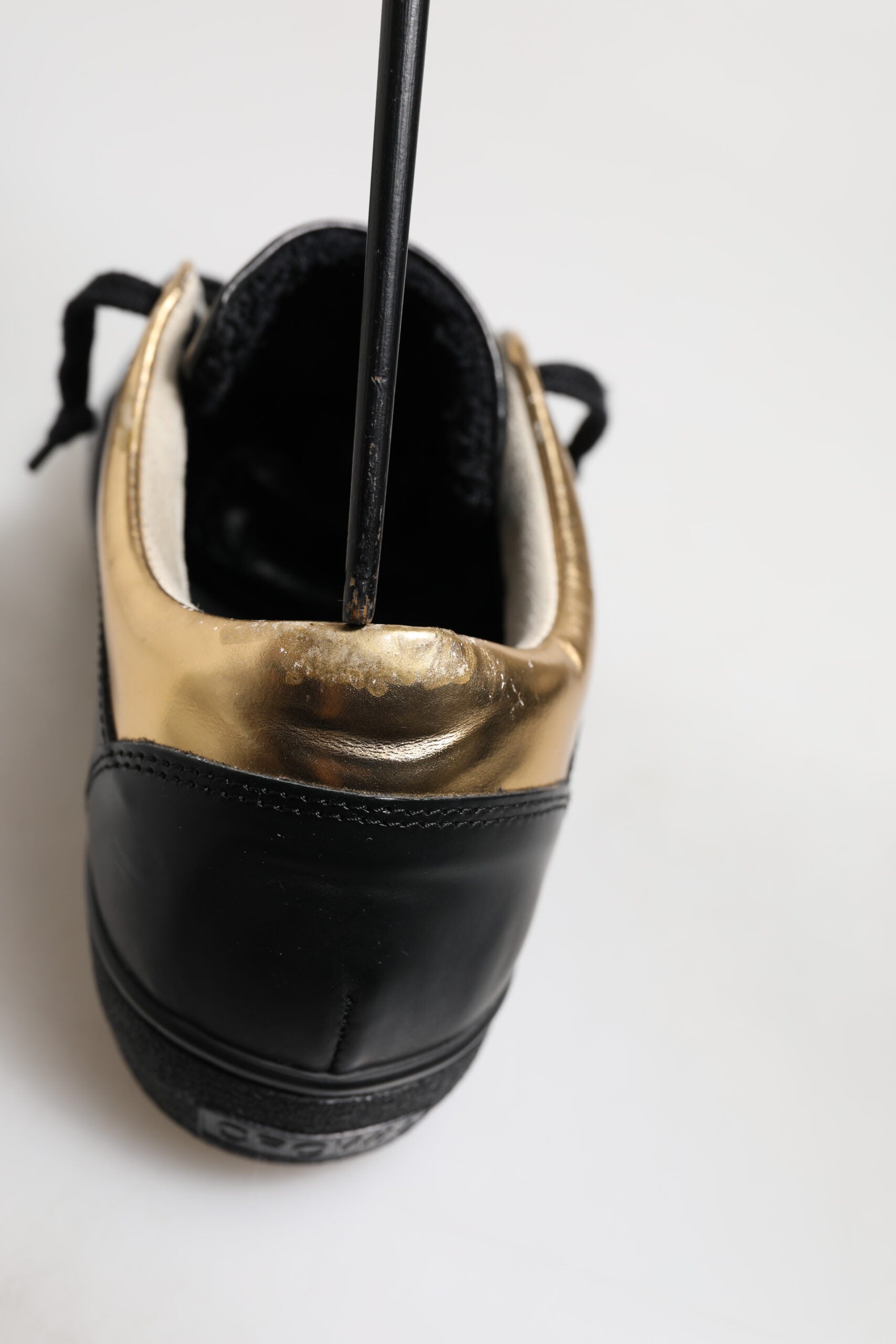 Black shoe with gold accents