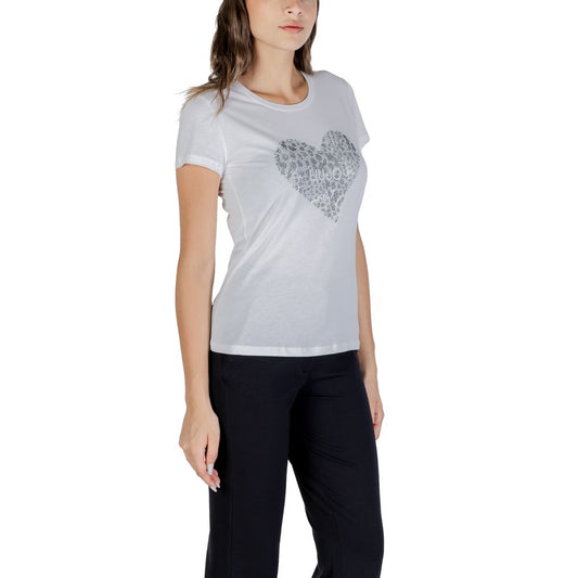 Woman wearing a white t-shirt with a heart design on it