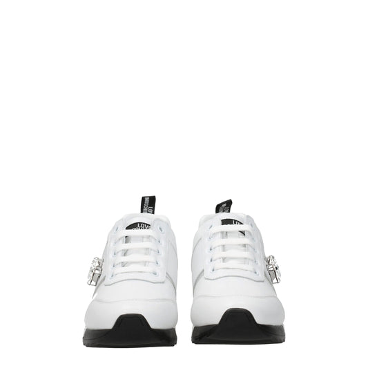 Pair of white leather low top sneakers with black laces, featuring a logo on the side and a buckle closure