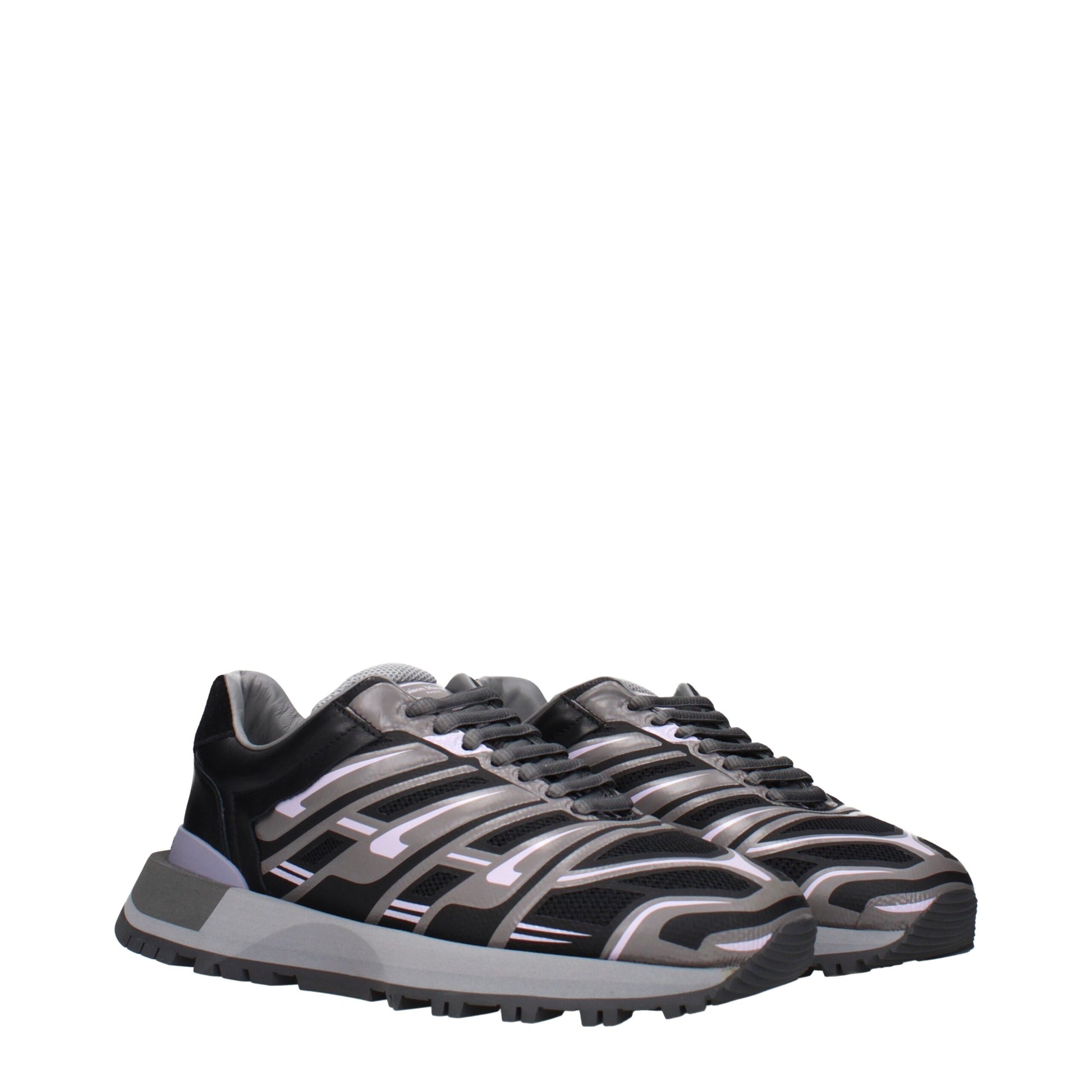 A pair of black athletic sneakers with white accents, featuring a unique design on the side and sole