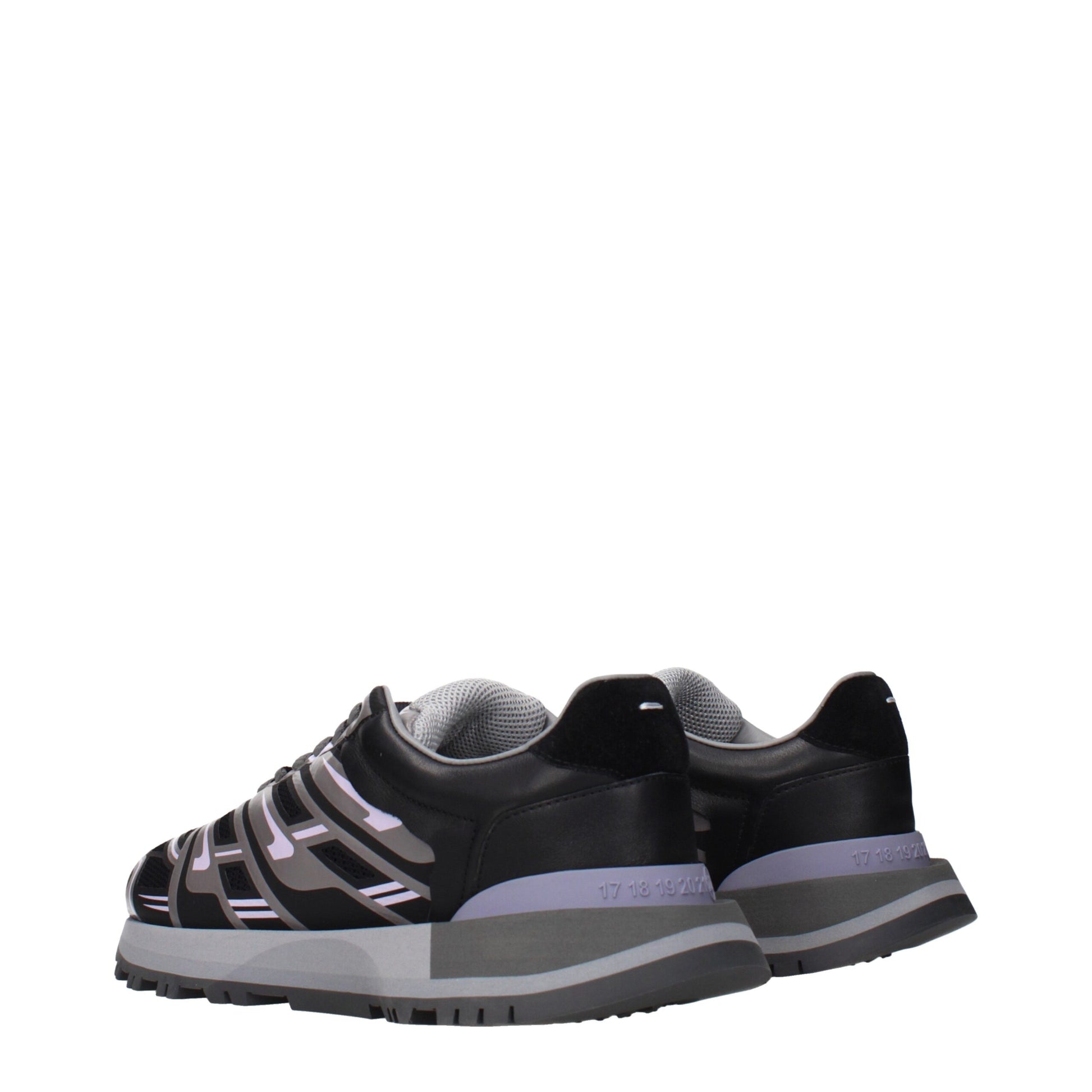 A pair of black athletic sneakers with white laces, featuring a strap across the top and a logo on the side